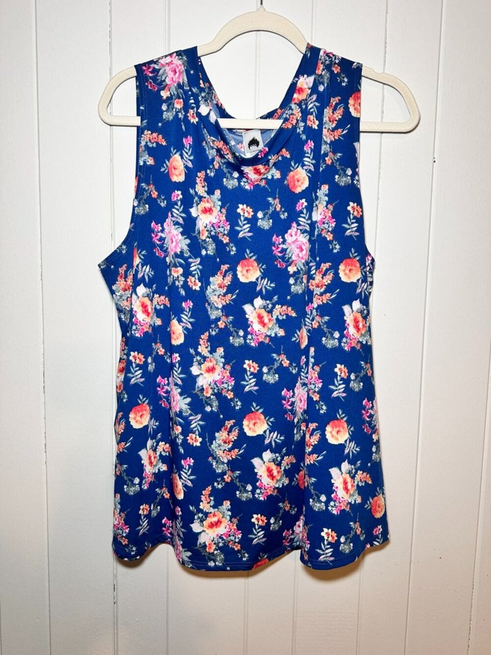 Sleeveless blue floral tank top styled, w/ vibrant orange, pink & white blossom